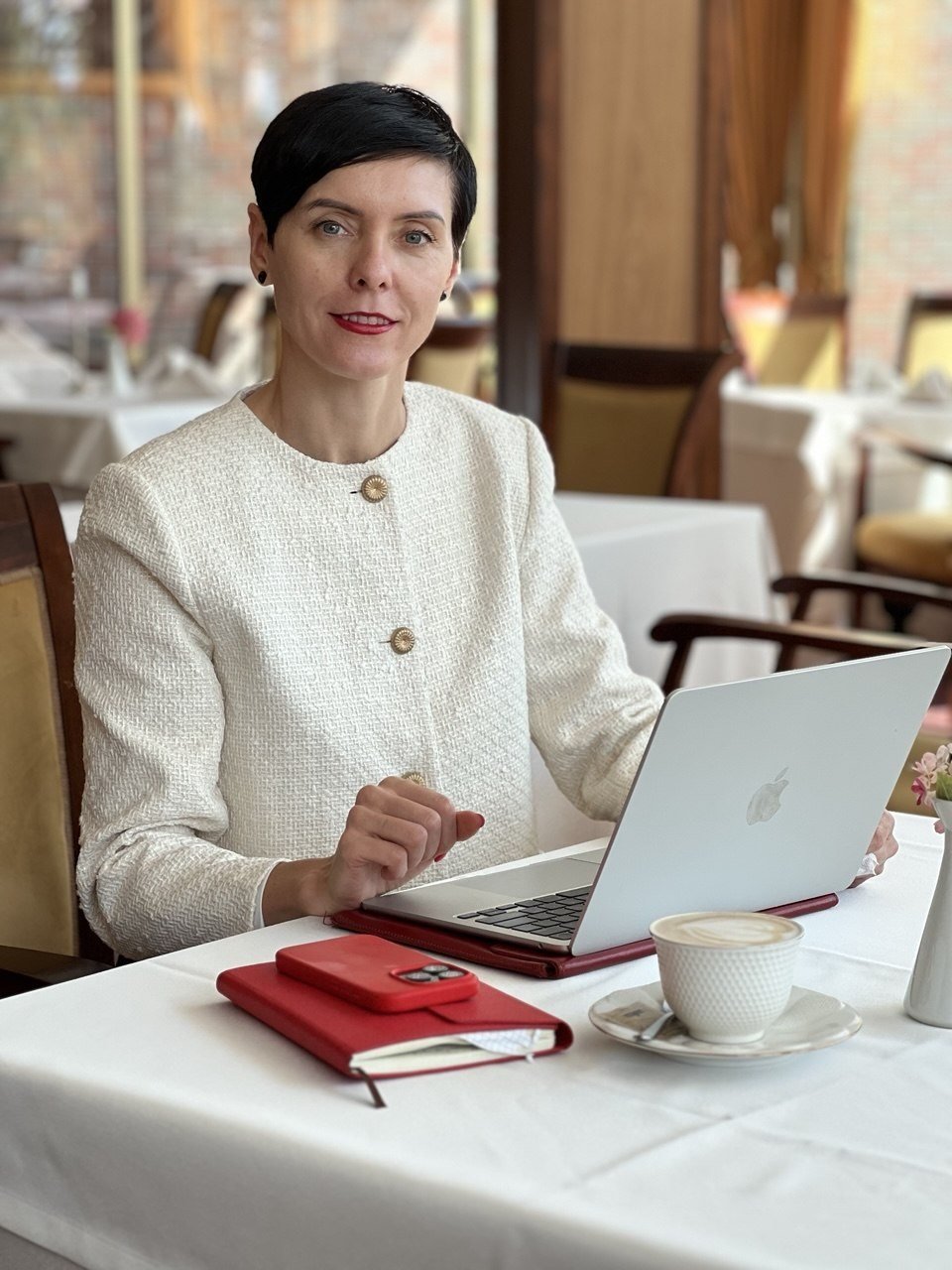 Natalia Tsadrouskaya, founder of TSN BALTIC, working at a laptop